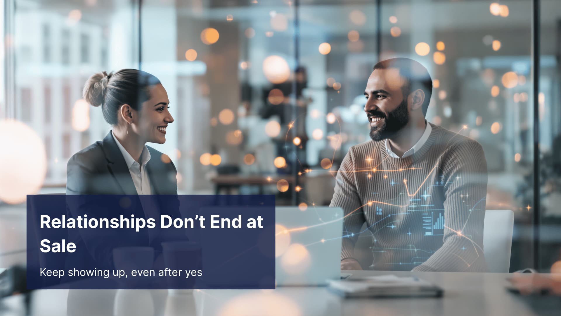 Two professionals smiling during a client meeting, representing post-sale relationship nurturing