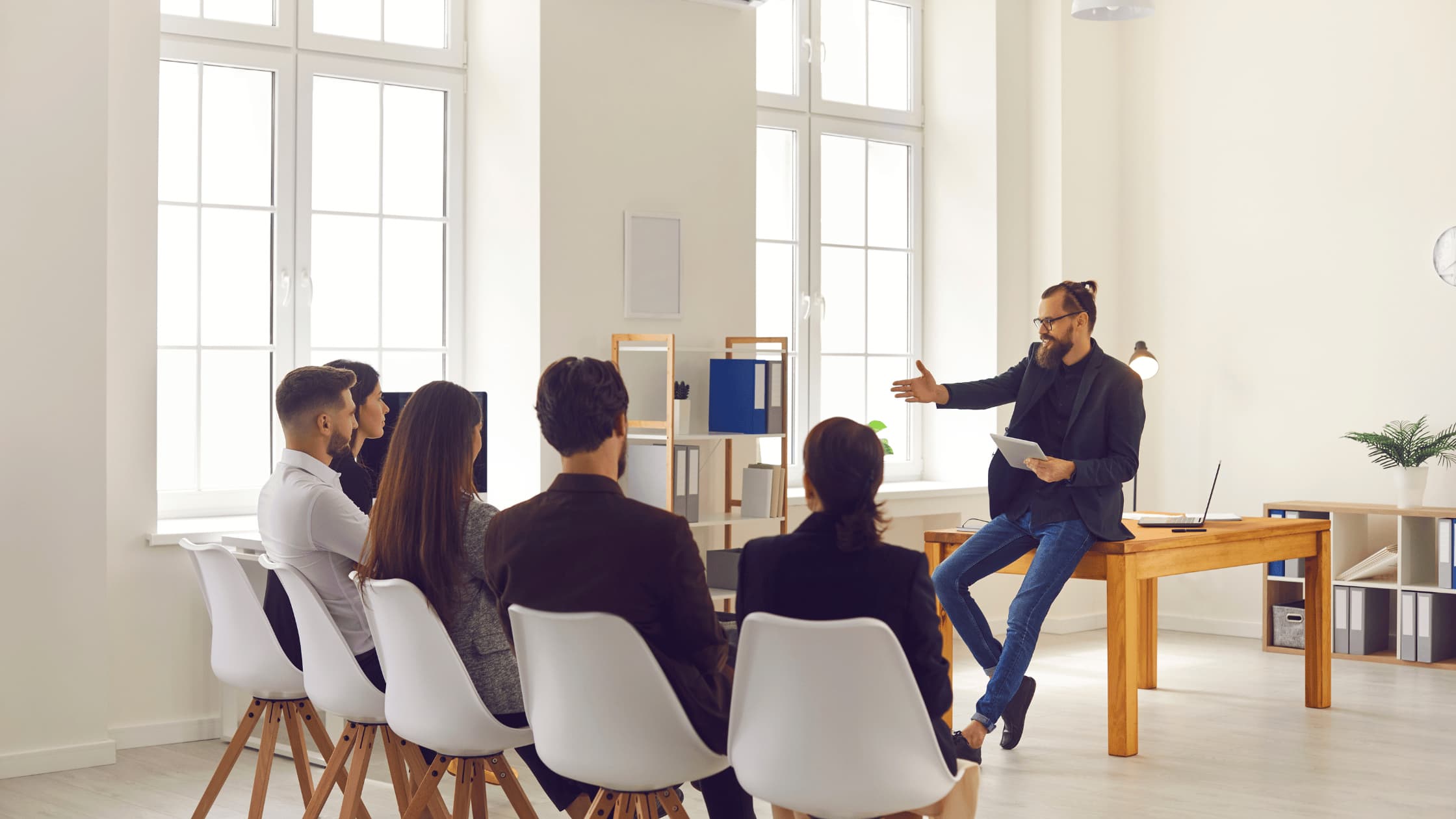 Manager presenting business strategy to employees in office